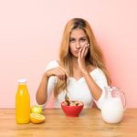 woman choosing foods and drinks to avoid after teeth whitening treatment